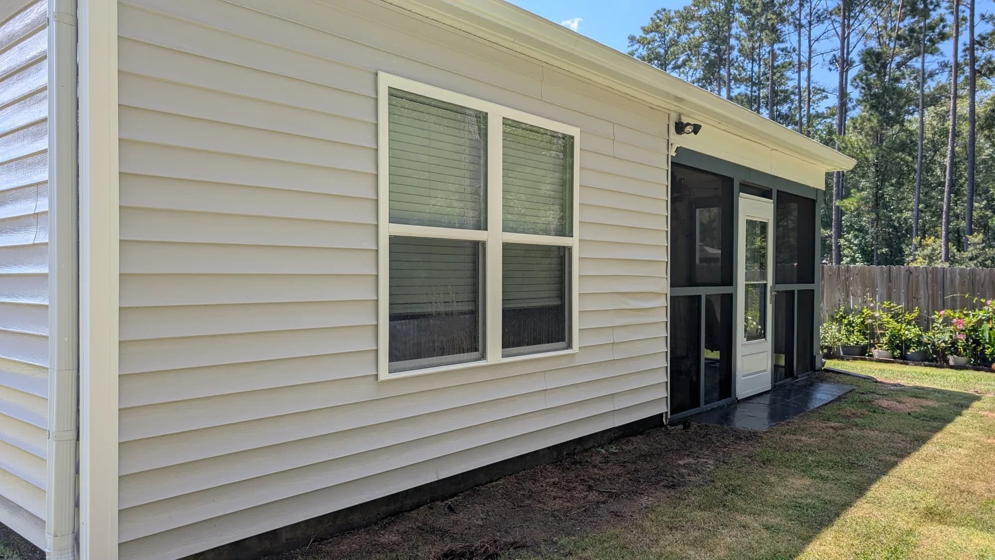 The same siding free of green algae after a soft wash